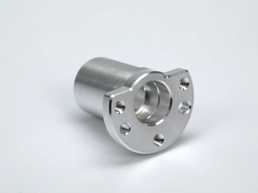 Metal machining part with flange