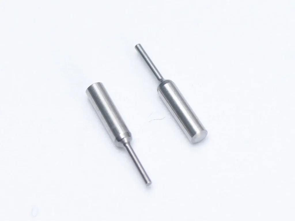 Metal pins on white background